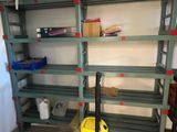 a yellow mop sitting on the floor in front of a shelf