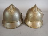 pair of antique brass helmets with lion heads on them