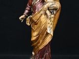 statue of a woman holding a child in her arms on a pedestal
