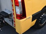 a yellow truck that is parked in the parking lot