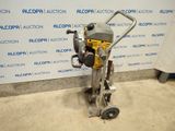 a close up of a machine on a dolly in front of a wall