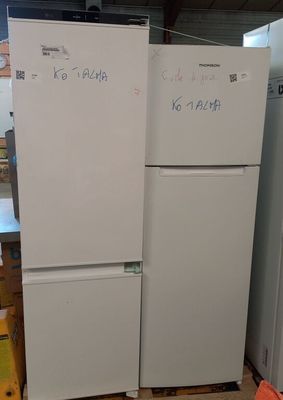 two refrigerators that are sitting in a warehouse