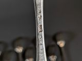 a silver spoon with a fork sticking out of it