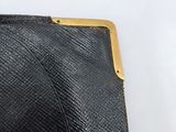 an image of a black purse with a gold clasp on a white background