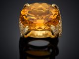 an orange sapphire and diamond ring
