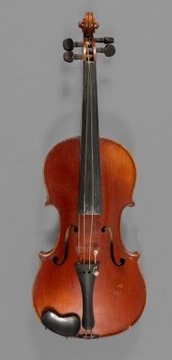 an old violin sitting on top of a table next to a gray wall