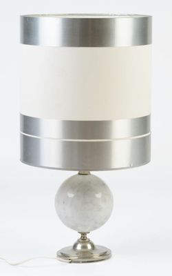 a lamp that is sitting on a table with a white shade