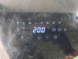 a close up of a digital clock on a stove