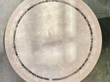 a round marble table with a black and white border
