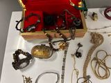 many different types of necklaces and bracelets on a table