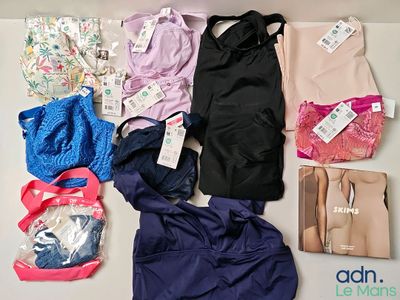 a lot of clothes and bags that are on the table