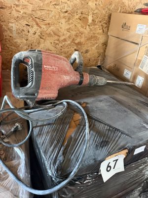 a red and black blow dryer sitting on top of a pile of boxes