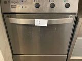 stainless steel dishwasher and oven in a kitchen with wood flooring