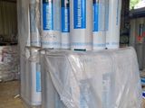 many rolls of plastic wrap on a pallet in a warehouse