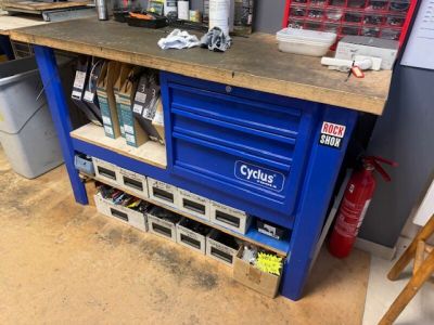 a blue workbench with a lot of tools on it