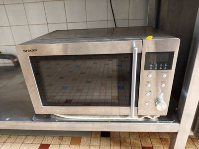 a microwave that is sitting on a table in the kitchen