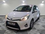 the toyota yaris is parked in a clean room with a checkered floor