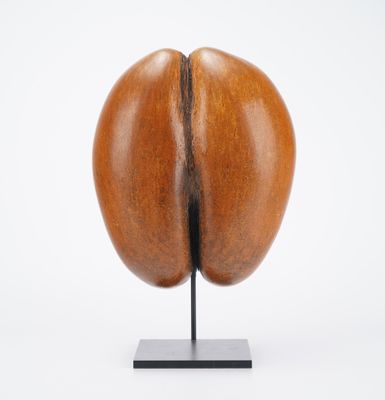 a close up of a sculpture of a coffee bean on a metal stand