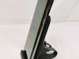 a cell phone that is on a stand on a table