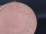 a close up of a vase with writing on it