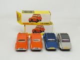 four toy cars that are sitting in front of a box