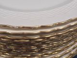 several white plates stacked on top of each other on a blue surface