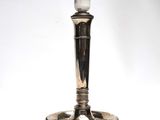 an image of a silver candle holder with a white light on top of it