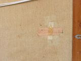 a piece of paper taped to a wall with a cross on it