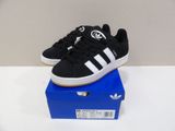 black and white adidas sneakers on a blue box on a white table
