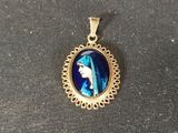 a close up of a pendant with a picture of a woman