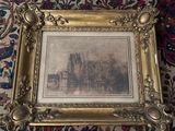 an old picture of a castle in a gold frame on a rug