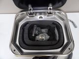a metal toilet with a black seat and a black lid