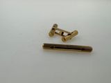a close up of a pair of brass screws on a white surface