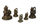 four bronze figurines of animals and birds on a white background