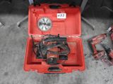 a red tool box with tools in it on the floor