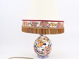 a lamp that is sitting on a table with a lamp shade on it
