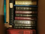 a box full of books that are stacked on top of each other