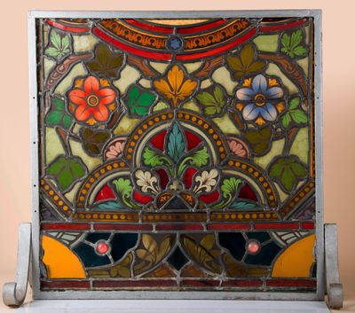 an old stained glass panel with flowers and leaves on it