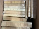 a lot of books in a box on the floor
