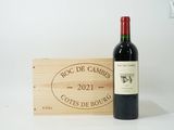 a bottle of wine sitting next to a wooden box