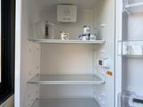 an open refrigerator that is sitting in the corner of a room