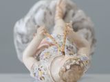 a figurine of a baby laying on its back