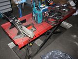a red table with tools on it in a garage