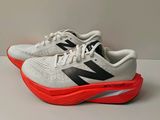 a pair of new balance shoes on a white surface