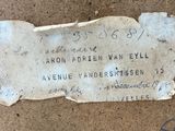 a piece of paper with writing on it sitting on the ground