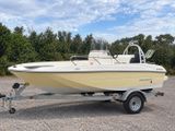 a small boat that is parked on the gravel