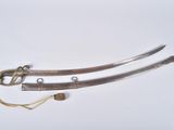 two swords that are laying on a white surface