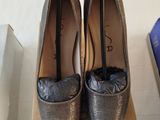 pair of women ' s shoes on a box on a white surface