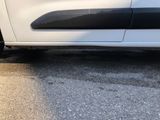 a white car parked on the side of the road