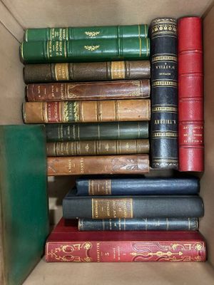 a box full of old books sitting on top of each other